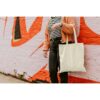 Woman carrying reusable blank canvas tote bag